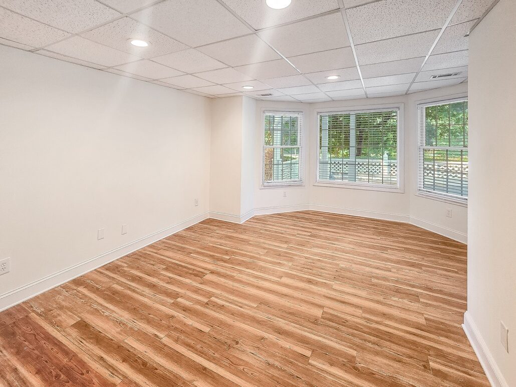 Basement bedroom with bay windows looking out to the covered patio at 1030 Billy Mantle Lane