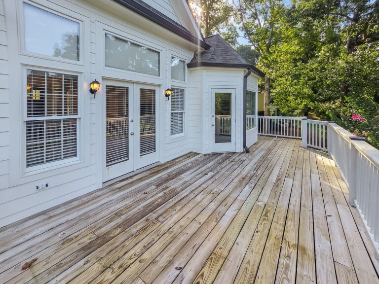 Main-level deck outside the living room French doors and the breakfast room at 1030 Billy Mantle Lane