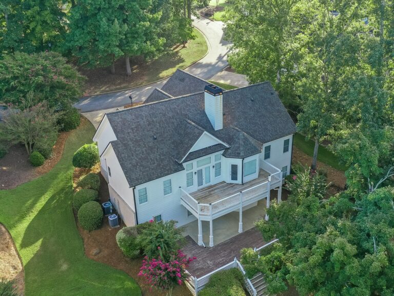 Aerial view of the back of 1030 Billy Mantle Lane showing the main-level deck with a covered patio beneath