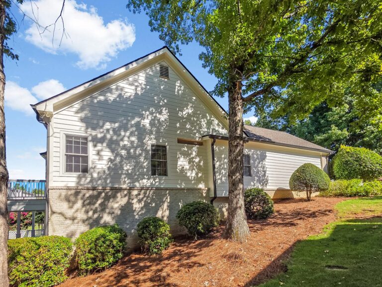 Side of 1030 Billy Mantle Lane with brick and siding and landscaped beds