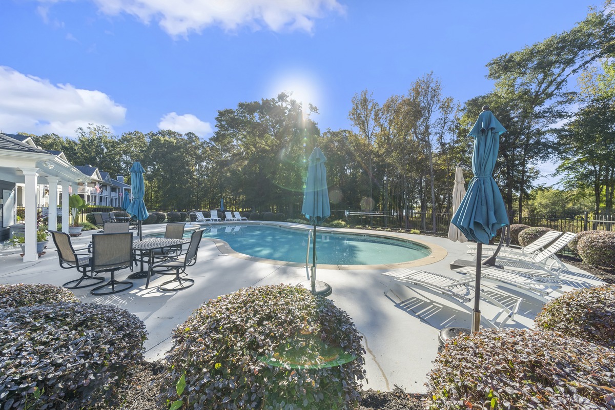 Pool deck with loungers and umbrellas at Carriage Cove on Lake Oconee