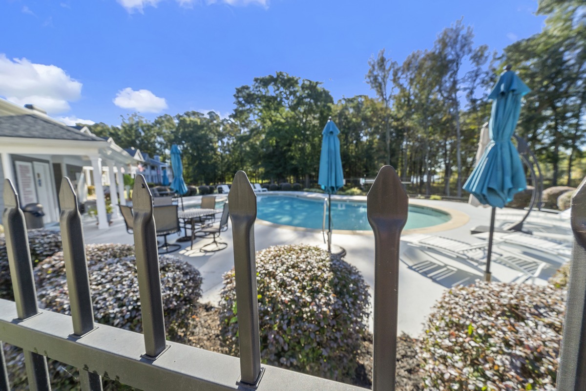 Community pool with blue umbrellas at Carriage Cove on Lake Oconee