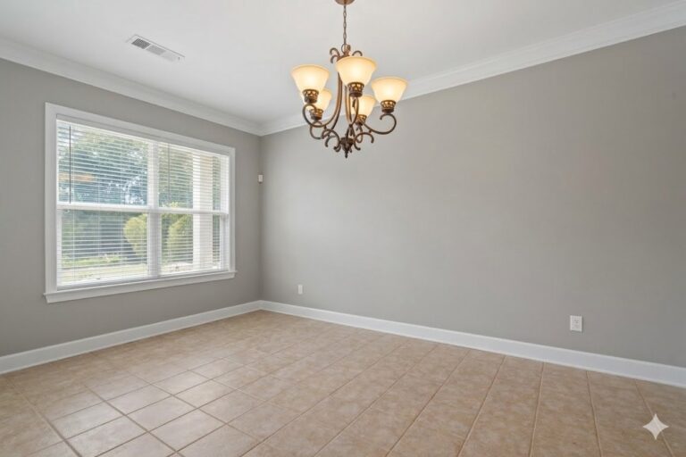 Dining area with a bronze chandelier and a window in an end-unit townhome at Lake Oconee