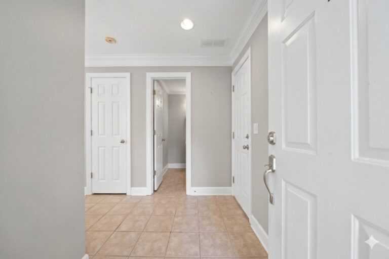 Entry hall with tile floors and six-panel doors inside the front door of a Lake Oconee townhome at 181-A Farriers Lane