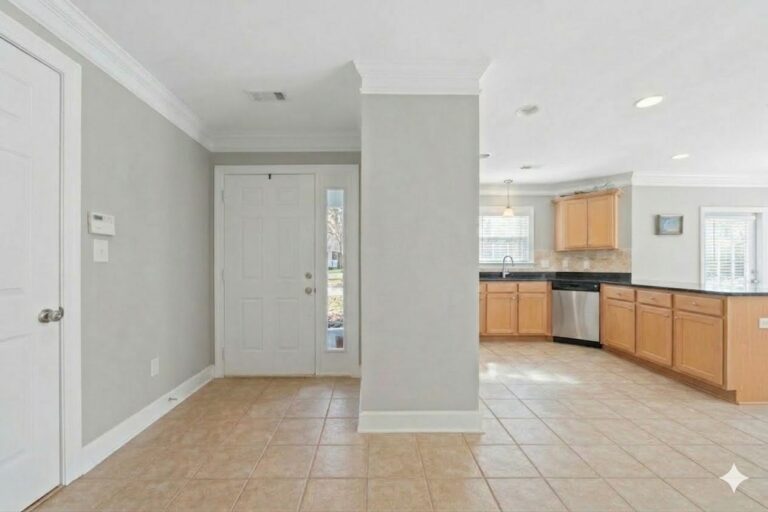 Front door with a sidelight and the view through to the kitchen in an Eatonton condo on Lake Oconee