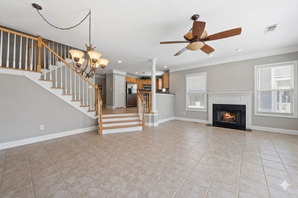 Open great room with the staircase, dining area and fireplace in a Lake Oconee townhome at 181-A Farriers Lane