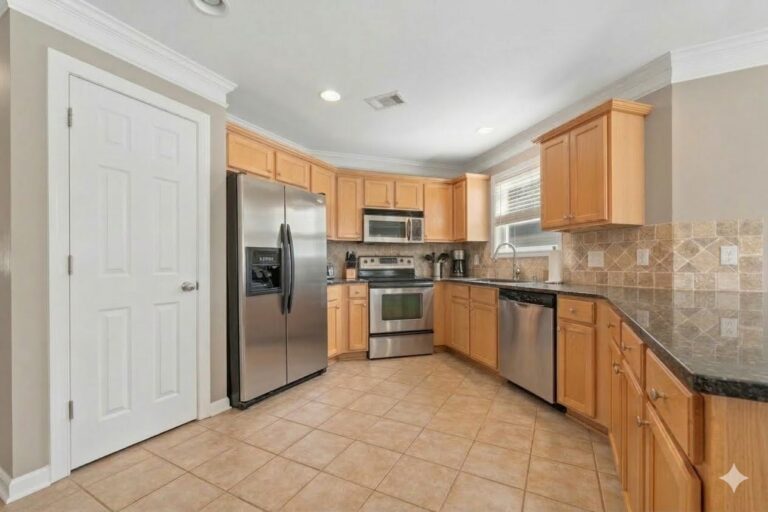 Kitchen with a stainless refrigerator, range and dishwasher in the Lake Oconee condominium at 181-A Farriers Lane