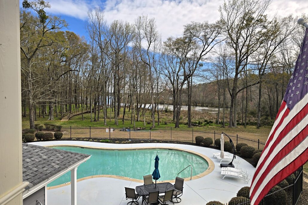 Community pool and the Lake Oconee cove through the trees, from the deck of the Carriage Cove condo at 181-A Farriers Lane