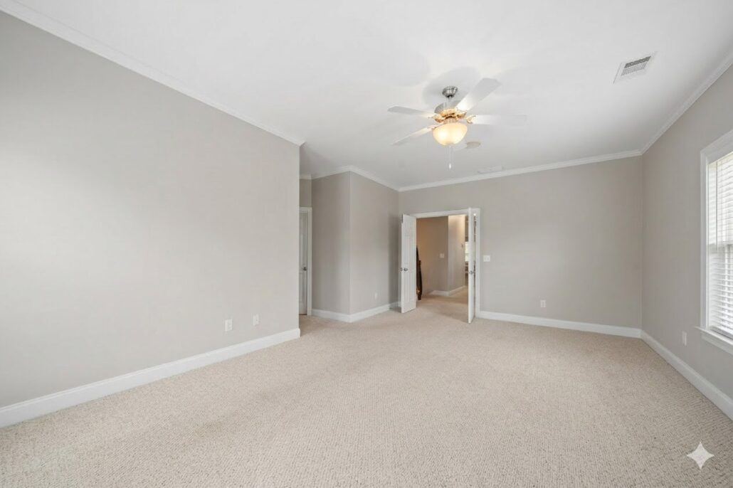 Primary bedroom with carpet, a ceiling fan and crown molding at 181-A Farriers Lane, a Lake Oconee condominium