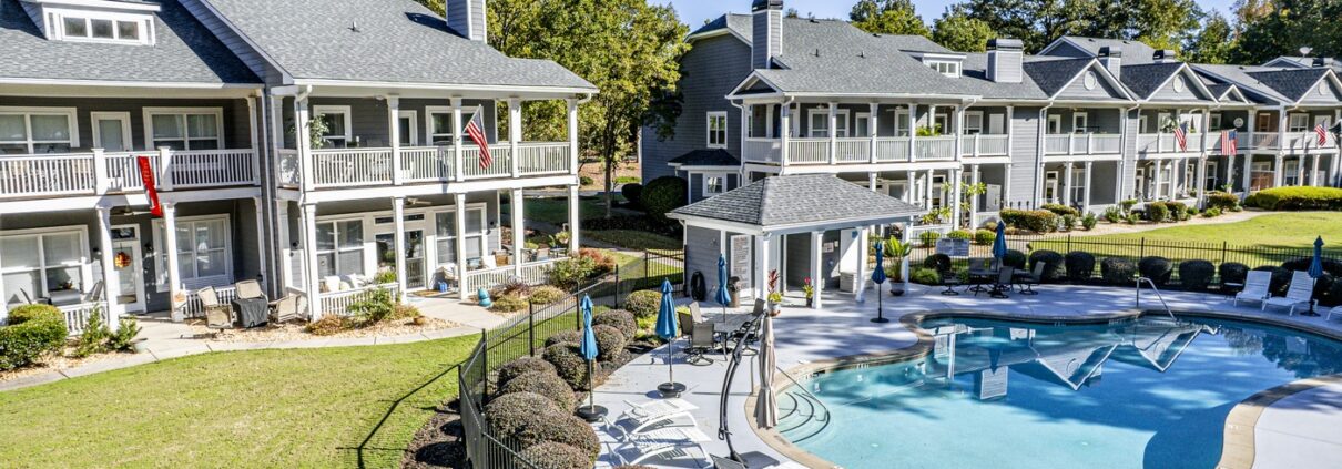 Back of 181-A Farriers Lane at Carriage Cove on Lake Oconee, with the community pool and pool house behind the building