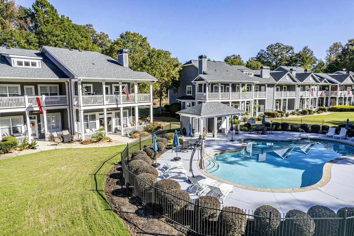 Back of 181-A Farriers Lane at Carriage Cove on Lake Oconee, with the community pool and pool house behind the building