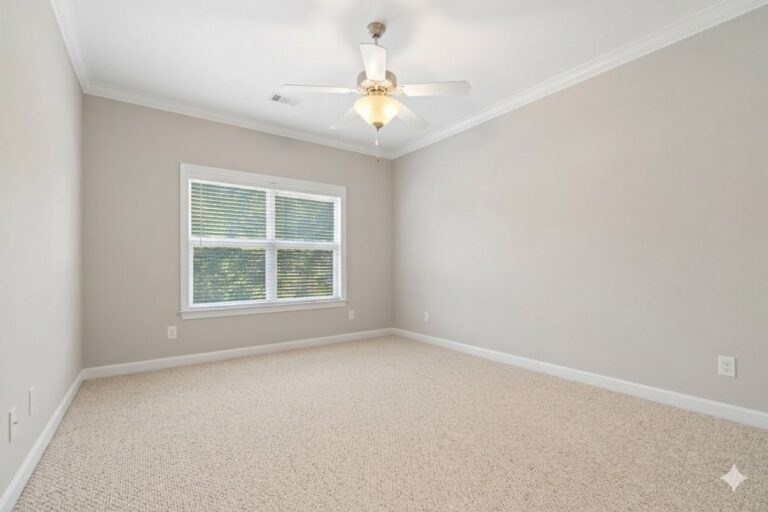 Carpeted upstairs room with a ceiling fan in the Lake Oconee condo at 181-A Farriers Lane