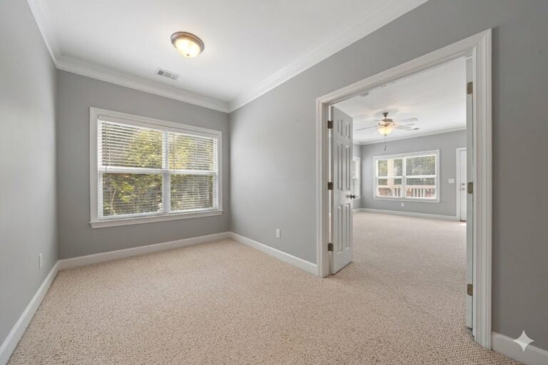 Upstairs room with double French doors open to the next room in an Eatonton townhome on Lake Oconee