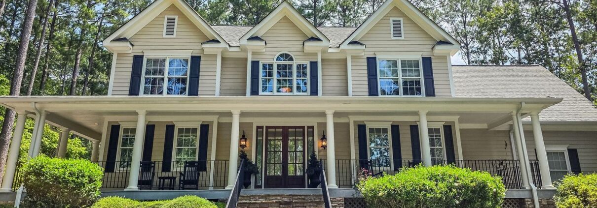 Front of 2750 Club Drive in Harbor Club on Lake Oconee, a two-story home with a covered wraparound porch