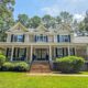 Front of 2750 Club Drive in Harbor Club on Lake Oconee, a two-story home with a covered wraparound porch