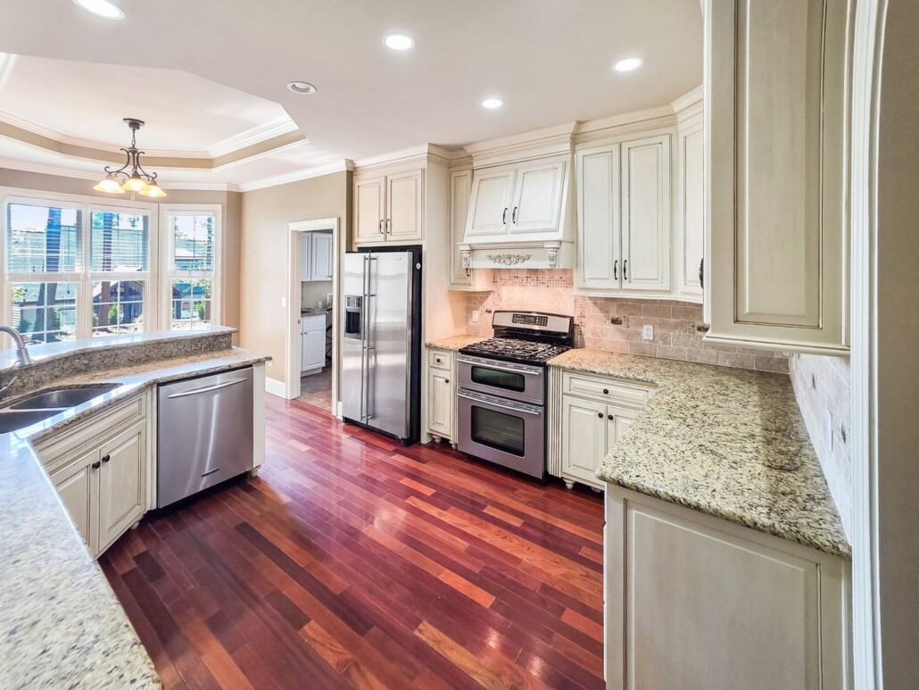 Kitchen at 2750 Club Drive with granite counters, cream cabinets and stainless appliances