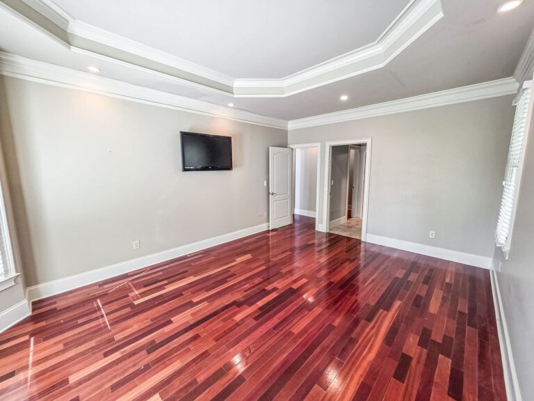Primary bedroom with hardwood floors and crown molding at 2750 Club Drive on Lake Oconee