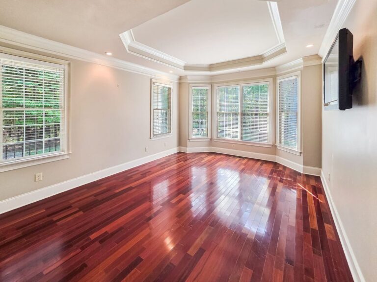 Main-level primary bedroom with a tray ceiling at 2750 Club Drive in Harbor Club