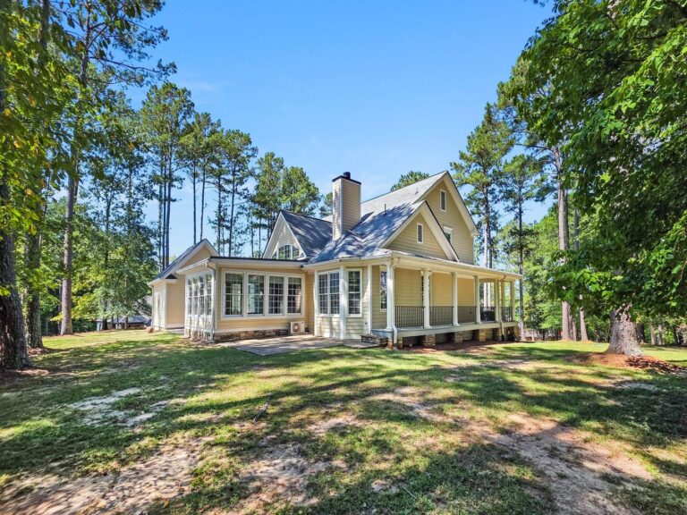 Wide view of the back of 2750 Club Drive with the sunroom and covered porch, Harbor Club