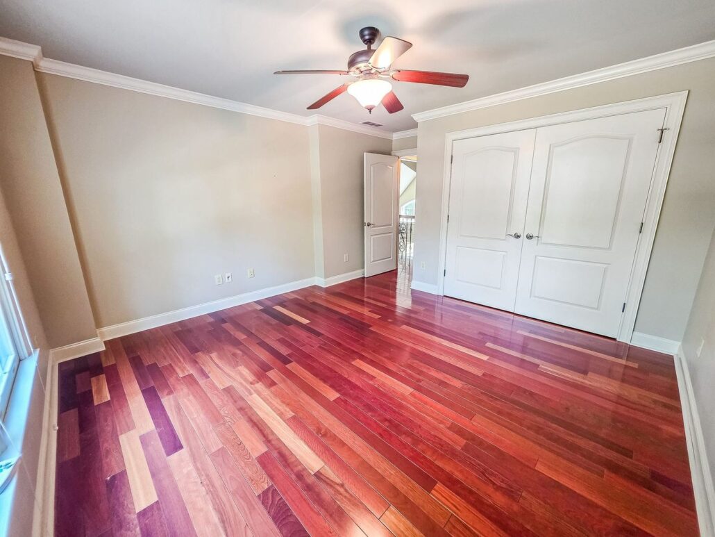Upstairs bedroom with hardwood floors and a double closet at 2750 Club Drive
