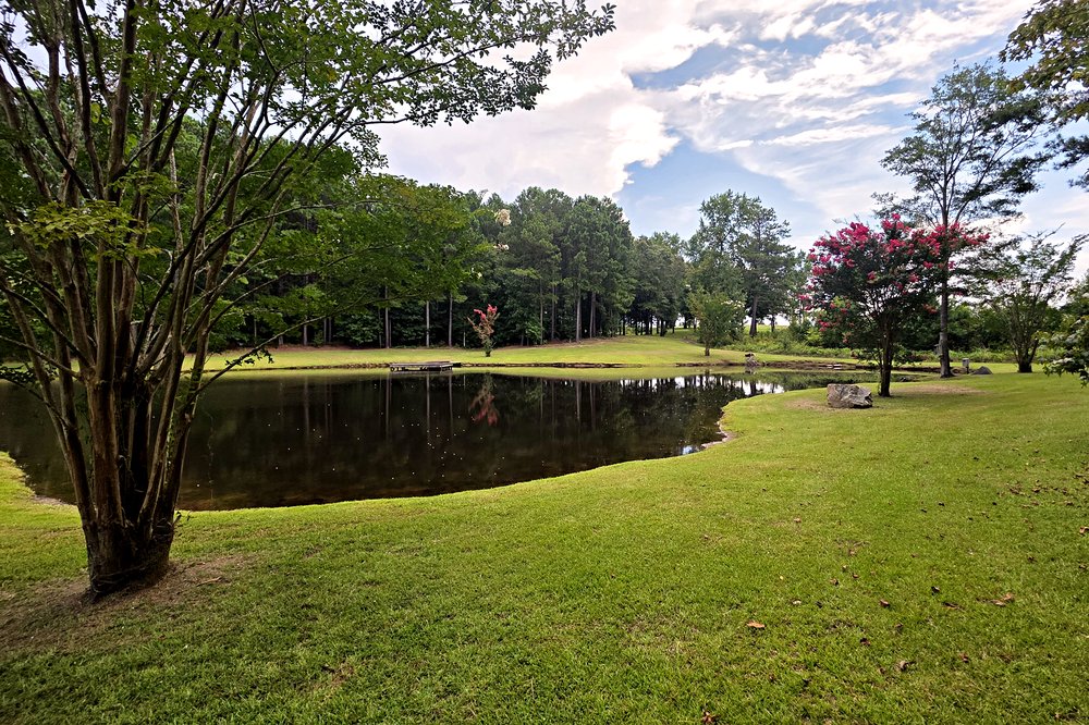 Landscaped community pond in the Emerald Shores neighborhood at Lake Oconee