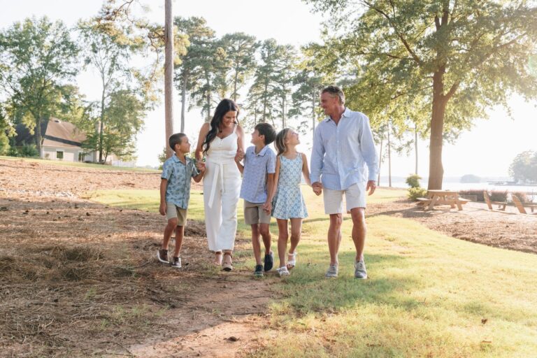 Margie Sorrell walking with her husband and three children along the lakefront at Lake Oconee