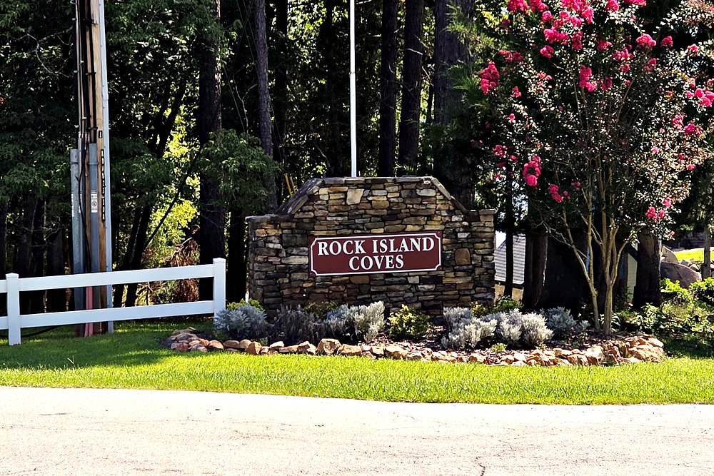 Rock Island Coves stone entrance sign among crepe myrtles on Lake Oconee
