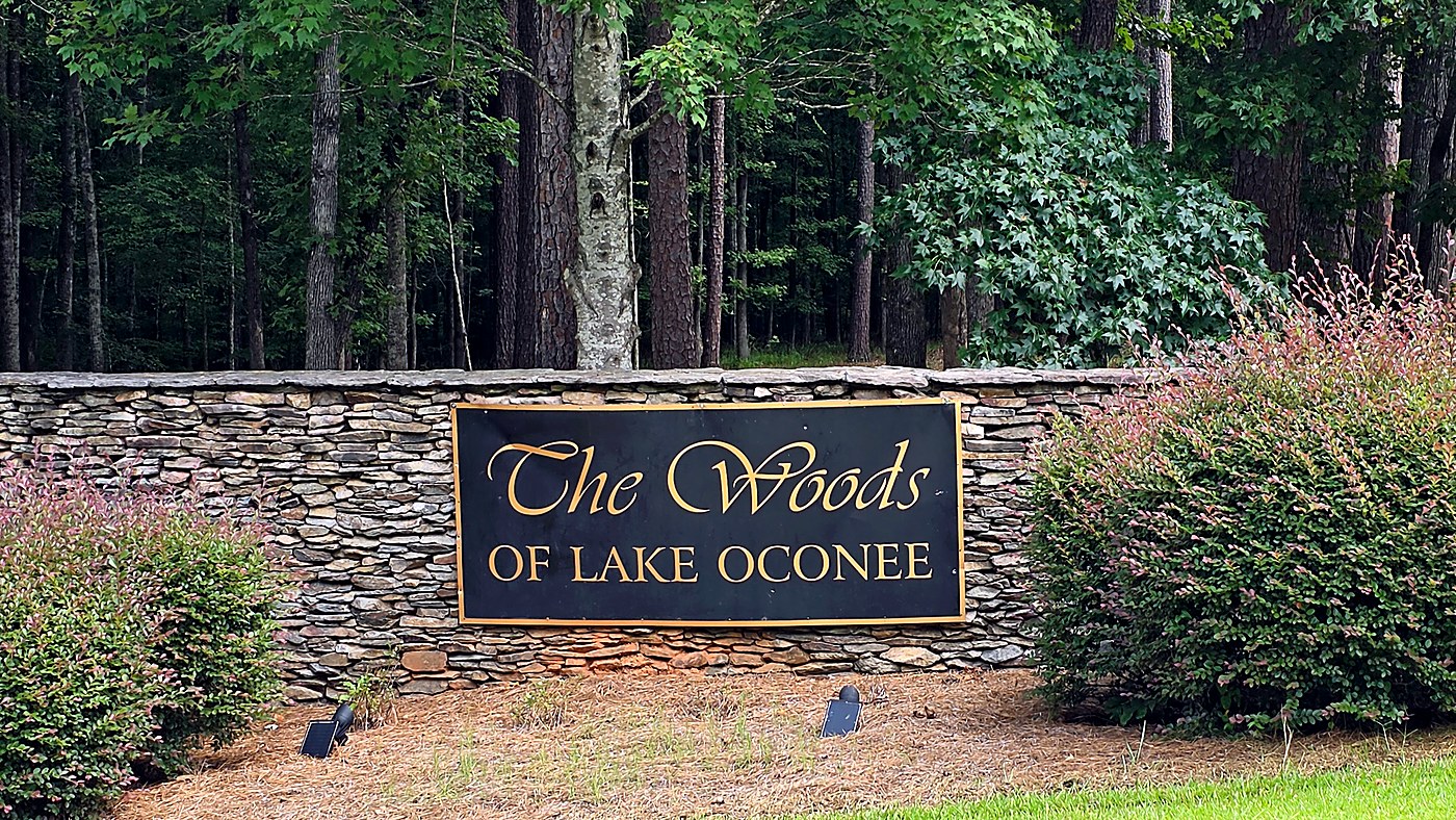 Stone entrance wall and sign for The Woods of Lake Oconee subdivision in Buckhead, Morgan County, Georgia