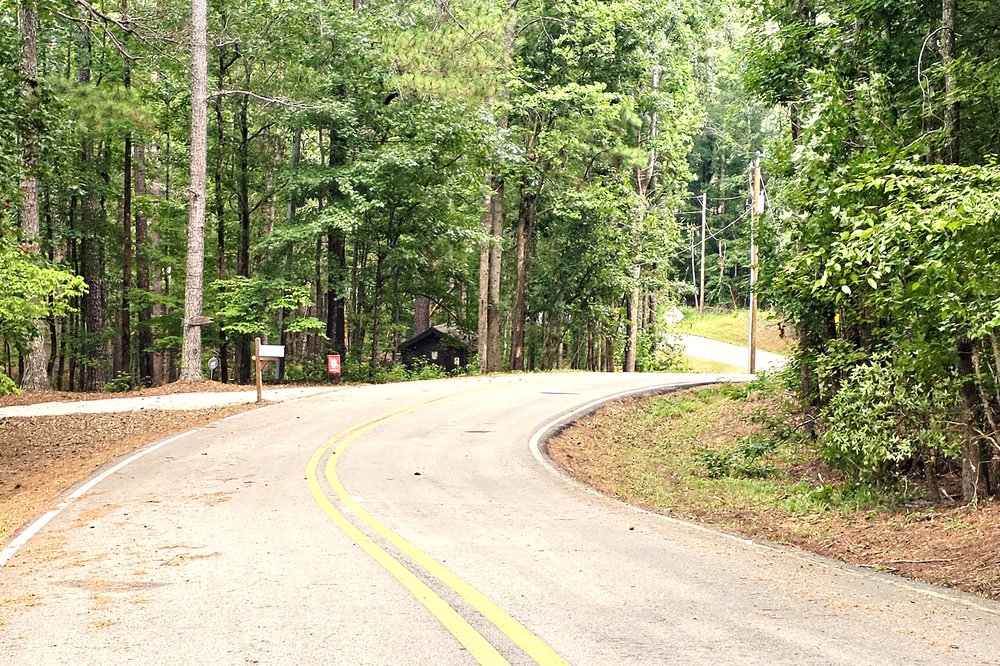 Quiet wooded road winding through Whispering Pines and Rocky Creek at Lake Oconee